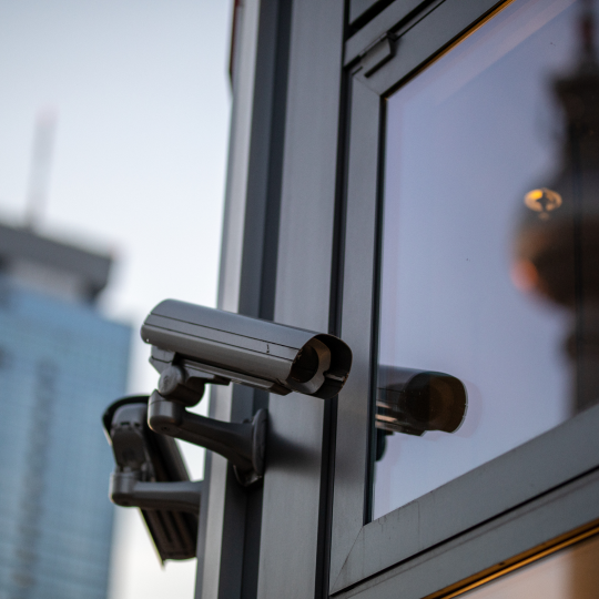 low-angle-view-security-camera-building-against-sky-sunse
